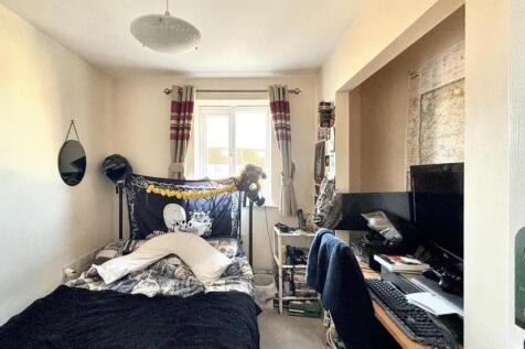 This inviting double bedroom features a cozy at...