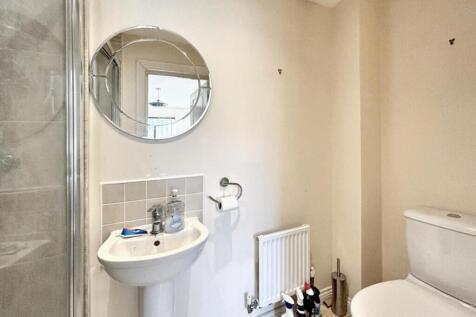 A modern bathroom featuring a sleek shower, con...