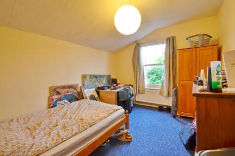 Cozy double bedroom featuring a comfortable bed...