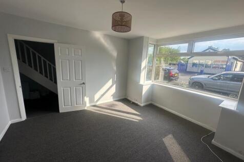 Bright and welcoming living room featuring a la...