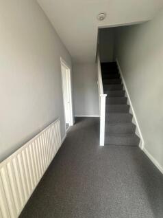 A clean and well-maintained hallway featuring n...