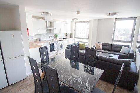 A spacious and modern living room featuring a s...