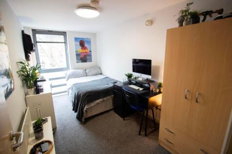 This cozy double bedroom features a comfortable...