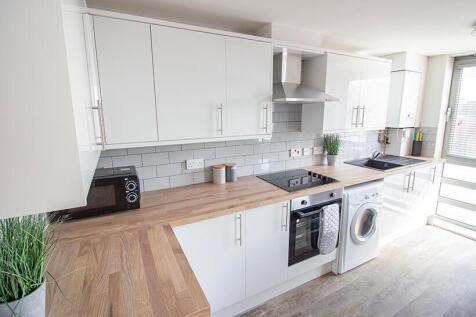 Bright and modern kitchen featuring sleek cabin...