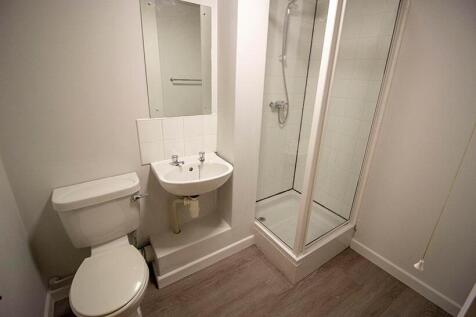 A modern bathroom featuring a sleek shower encl...