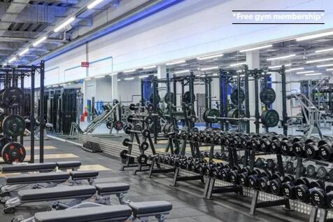 Experience a vibrant and spacious gym area equi...