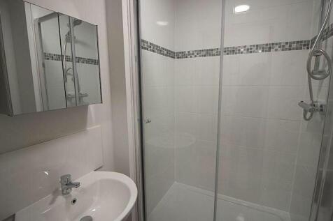 Modern bathroom suite featuring a stylish showe...