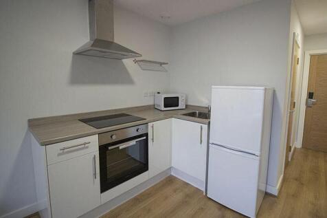 Modern kitchenette featuring sleek cabinetry an...
