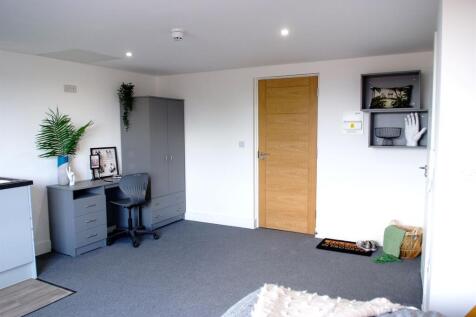 A stylish and cozy double bedroom featuring a w...