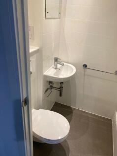 This modern single toilet features a sleek desi...