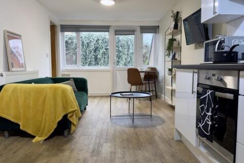 A spacious and modern living room featuring a c...