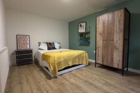A bright and inviting double bedroom featuring ...