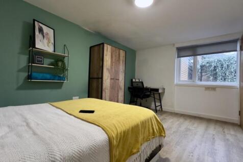 A bright and tidy double bedroom featuring a co...