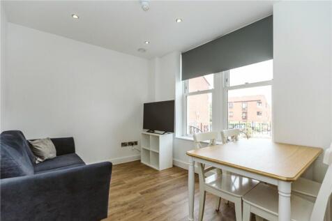 A bright and inviting living room featuring a c...