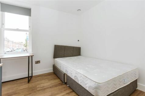 This inviting double bedroom features a comfort...