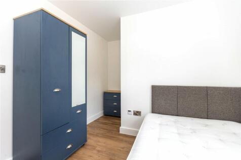 This inviting double bedroom features a stylish...