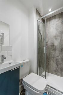 A modern bathroom featuring a stylish shower en...
