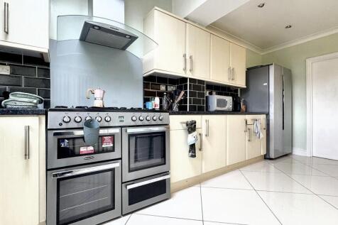 Spacious and modern kitchen featuring ample sto...