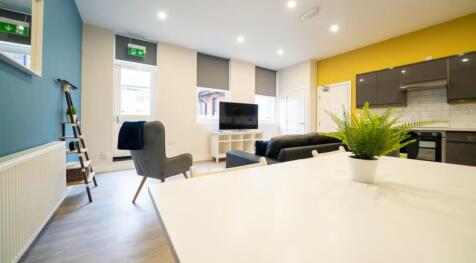 Bright and modern living room featuring large w...