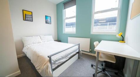 Bright and inviting double bedroom featuring la...
