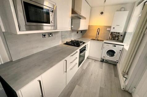 This modern kitchen features sleek cabinetry an...