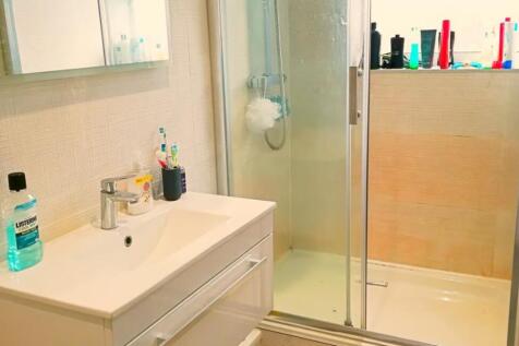 Bright and modern bathroom featuring a sleek sh...