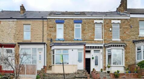Charming facade of a terraced house featuring b...