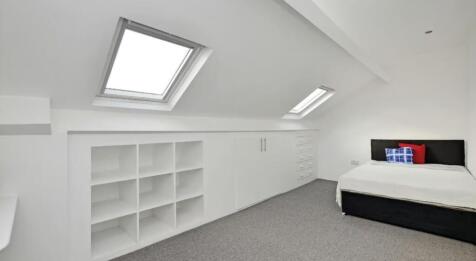 This inviting double bedroom features spacious ...