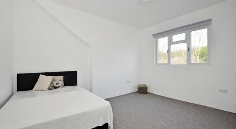 This inviting double bedroom features a cozy at...
