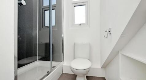 A modern bathroom featuring a sleek shower and ...