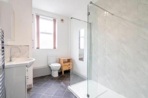This stylish bathroom features a spacious showe...