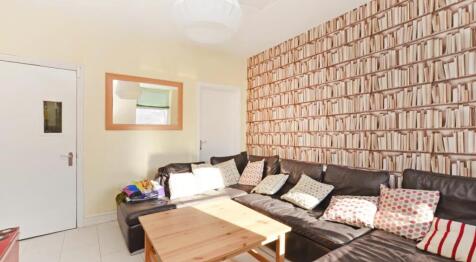A cozy living room featuring a stylish sofa ado...
