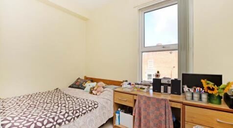 This cozy double bedroom features a comfortable...