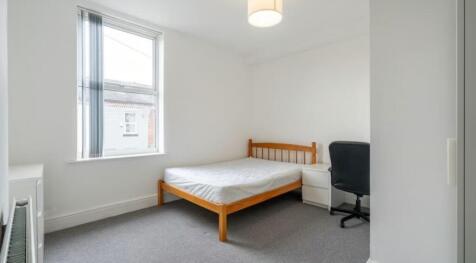 This cozy double bedroom features a comfortable...