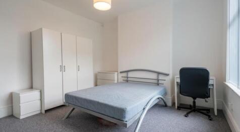 This inviting double bedroom features a comfort...