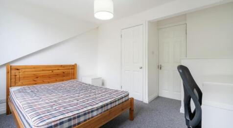 Bright and cozy double bedroom featuring a comf...