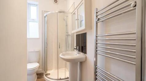 This modern bathroom features a stylish shower ...