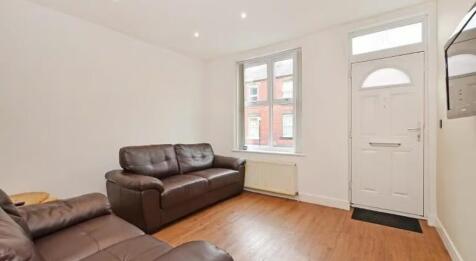 A bright and inviting living room featuring com...
