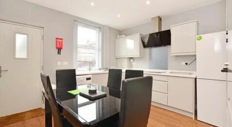 A modern kitchen featuring sleek cabinetry, a s...
