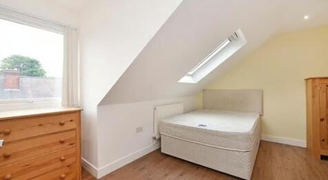 Bright and cozy double bedroom featuring a comf...