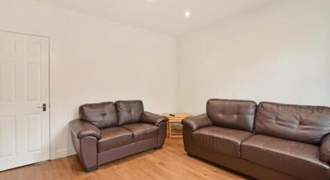 A cozy living room featuring comfortable leathe...