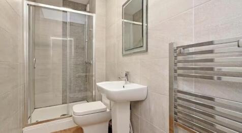 Modern bathroom suite featuring a sleek shower,...