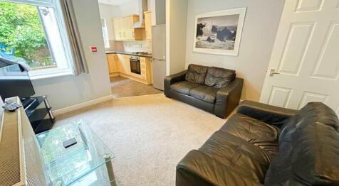 This inviting living room boasts ample natural ...