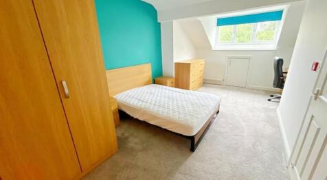 Bright and spacious double bedroom featuring a ...