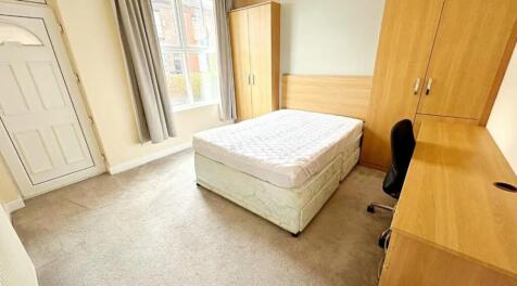 Spacious double bedroom featuring a comfortable...
