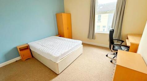 This inviting double bedroom features a comfort...