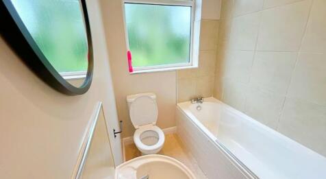This contemporary bathroom features a spacious ...