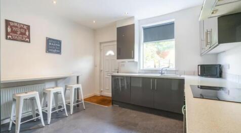This modern kitchen features a sleek design wit...