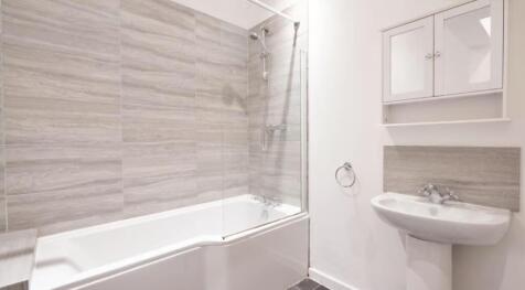 A modern bathroom featuring a sleek design with...