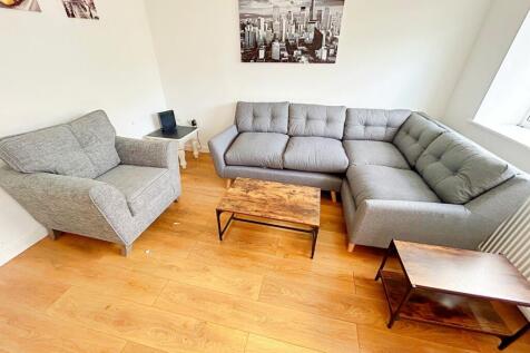 This contemporary living room features a cozy s...